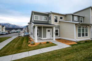 View of front facade with a mountain view and a front yard