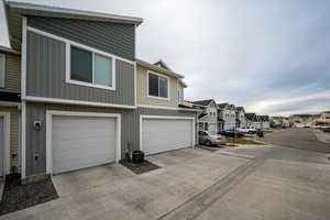 Exterior space with central AC and a garage