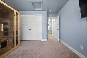 Carpeted bedroom featuring a closet