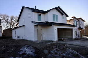 Back of property with a garage