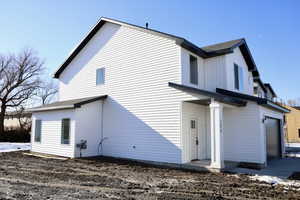 Rear view of house with a garage