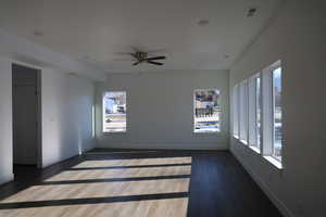 Unfurnished room with ceiling fan and dark flooring