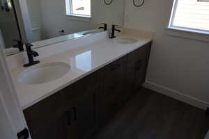 Bathroom featuring plenty of natural light, toilet, wood-type flooring, and vanity