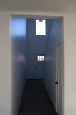 Hallway with hardwood / wood-style flooring and a wealth of natural light