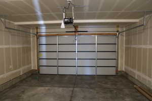 Garage featuring a garage door opener