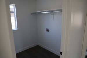 Washroom featuring dark wood-type flooring and hookup for a washing machine