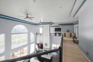 Corridor featuring light carpet and ornamental molding