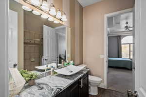 Bathroom featuring walk in shower, vanity, ceiling fan, hardwood / wood-style floors, and toilet