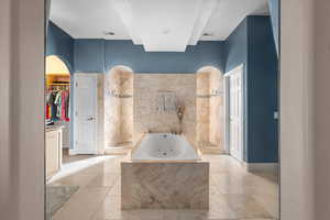 Bathroom featuring tiled tub