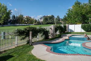 View of pool with a yard