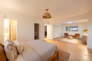 Bedroom featuring light hardwood / wood-style floors and ornamental molding