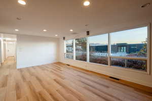 Spare room featuring light wood-type flooring