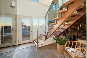 Staircase with a towering ceiling