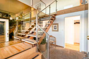 Stairs featuring hardwood / wood-style floors