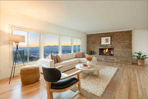 Living room featuring hardwood / wood-style floors, ornamental molding, and a fireplace