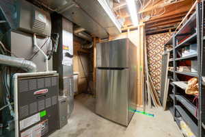 Basement with stainless steel refrigerator