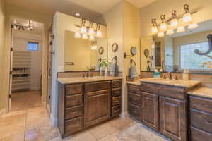 Primary bath double vanities & entrance into walk-in-closet