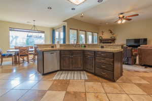 Kitchen looking out to great room, semi-formal eating area & French doors out to a large covered patio