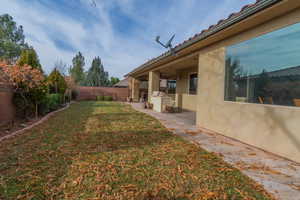 Back of home, yard & covered patio