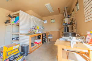 Workbench in garage with walls & hooks to organize tools