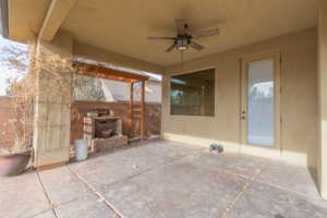 Covered patio/terrace with BBQ & a brick water fountain with an electric pump