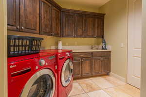 Laundry room with amply cabinets & counters. Washer and dryer included with home