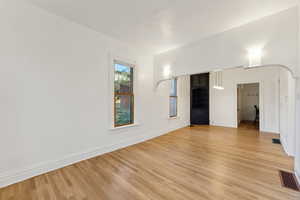 Empty room with light hardwood / wood-style floors