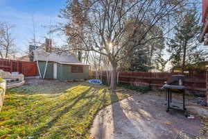 View of yard with a patio area and an outdoor structure