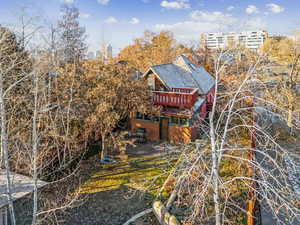 Rear view of property with a deck, a yard, and a patio