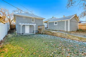 Back of property with a yard and a pergola