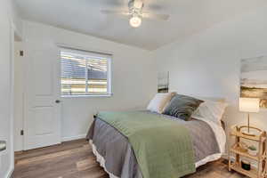 Bedroom featuring wood-type flooring and ceiling fan