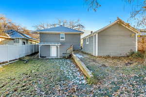 Rear view of property featuring a yard and a pergola