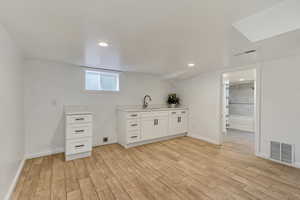 Interior space featuring light hardwood / wood-style flooring and sink