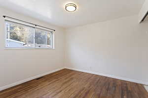 Spare room with wood-type flooring