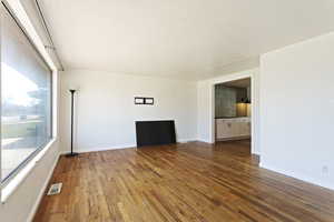 Unfurnished living room featuring hardwood / wood-style floors