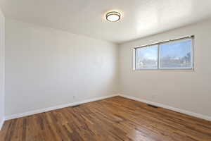 Unfurnished room featuring wood-type flooring