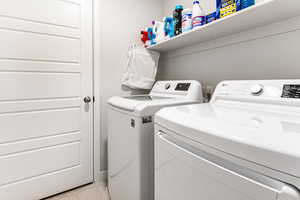 Clothes washing area featuring washer and clothes dryer