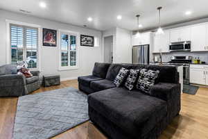 Living room with light wood-type flooring