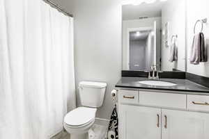 Bathroom with tile patterned floors, vanity, and toilet