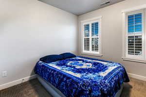 Bedroom with carpet floors and a textured ceiling