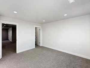 Unfurnished bedroom featuring dark colored carpet