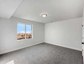 Empty room with carpet and a textured ceiling