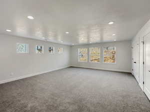 Spare room featuring a textured ceiling and plenty of natural light