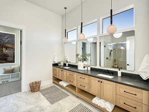 Bathroom featuring vanity and an enclosed shower