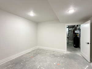 Basement with a textured ceiling