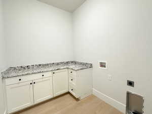 Laundry room with cabinets, hookup for a washing machine, light wood-type flooring, and electric dryer hookup