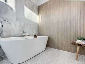 Bathroom featuring tile walls and a bathing tub