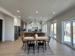 Dining area featuring a chandelier and light hardwood / wood-style floors