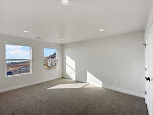 Carpeted empty room with a textured ceiling