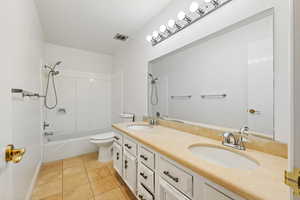 Full bathroom with tile patterned floors, vanity, shower / bathing tub combination, and toilet